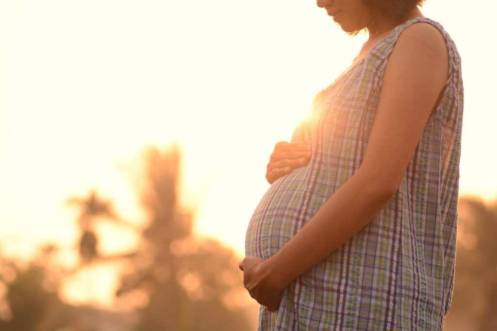 Pregnant woman at sunset