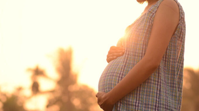 Pregnant woman at sunset